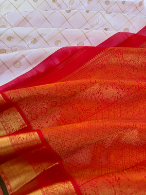 Statement of Kanchivaram - KK2 - one of kind and most fresh from the loom venn pattu ( pure tone of off white ) with red korvai woven solid gold borders with elephant motifs. The paisley and rudurakasham woven kattam buttas add more beauty to the sari !!