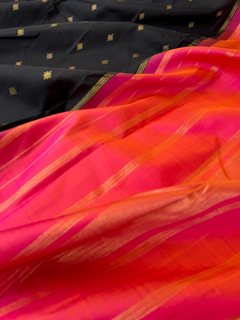 It is all about borderless kanchivarams - black body with orange short pink pallu and blouse