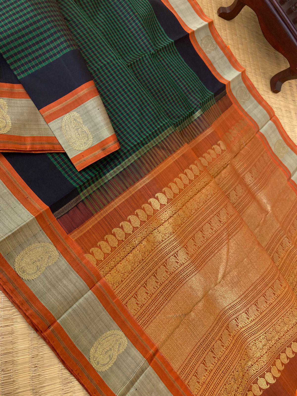 Heriyae - Molten Mettalic Kanchivarams - stunning metallic black and dark green vaari and kattam woven body with rust orange pallu and blouse