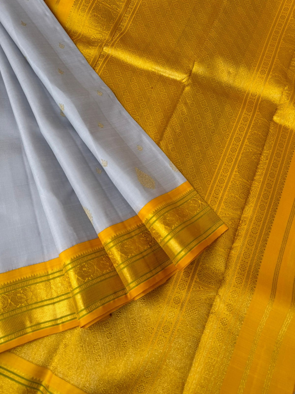 Pastel Ragas on Kanchivaram - gorgeous silver grey and golden yellow with beetu buttas woven borders