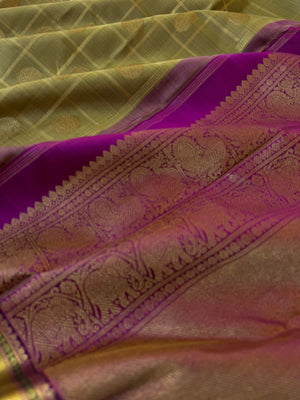 Radhee - Rare Find Kanchivarams - stunning deep elachi green and majenta mayil chackaram with solid gold zari woven borders