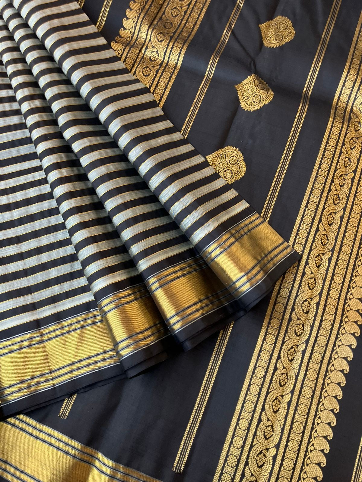 Leela - Darker effects on Kanchivaram - gorgeous black and grey stripes woven body highlighted with gold zari stripes !!