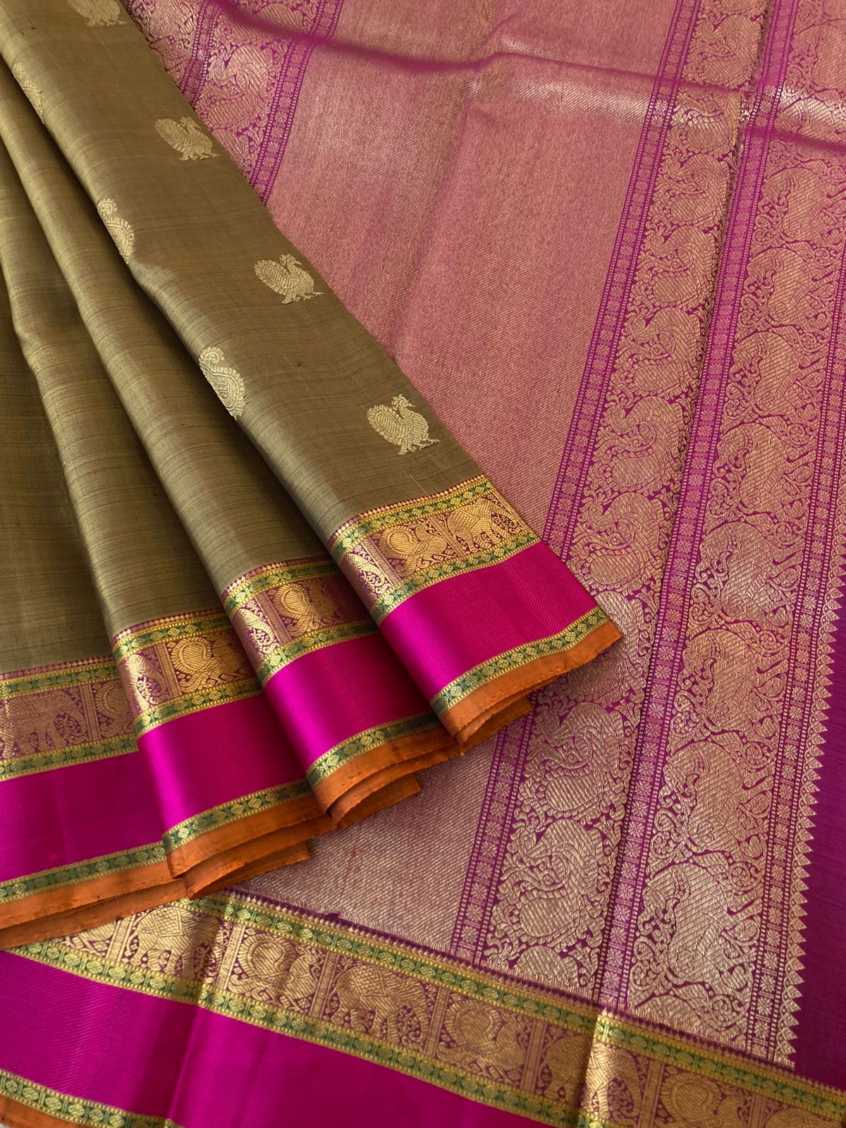 Heriyae - Molten Mettalic Kanchivarams - gorgeous metallic fenugreek bronze tone paisley and annapakshi woven buttas with majenta purple elephant motifs borders with grandest pallu