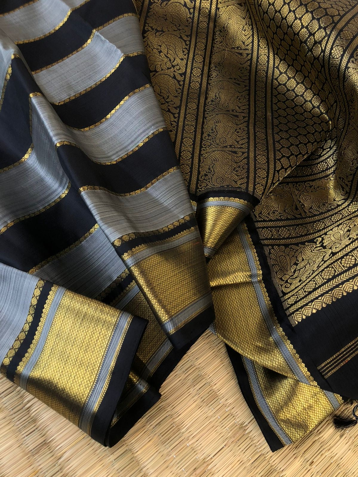 Radhee - Rare Find Kanchivarams - stunning black and grey train track veldhari body with gold zari borders and pallu