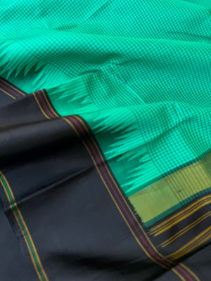 Bliss of Korvai Kanchivaram - deep mint green posi kattam woven body with black borders pallu and blouse