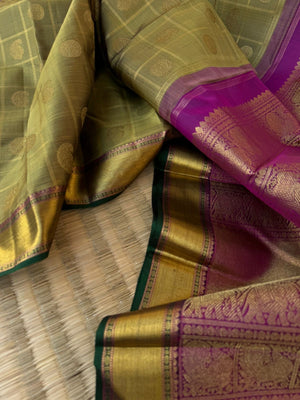 Radhee - Rare Find Kanchivarams - stunning deep elachi green and majenta mayil chackaram with solid gold zari woven borders