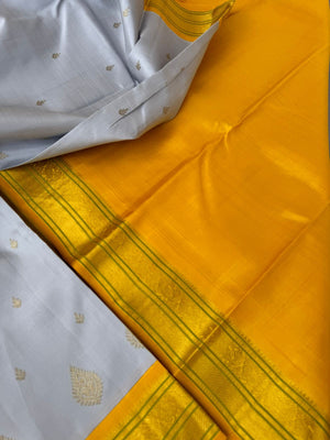 Pastel Ragas on Kanchivaram - gorgeous silver grey and golden yellow with beetu buttas woven borders