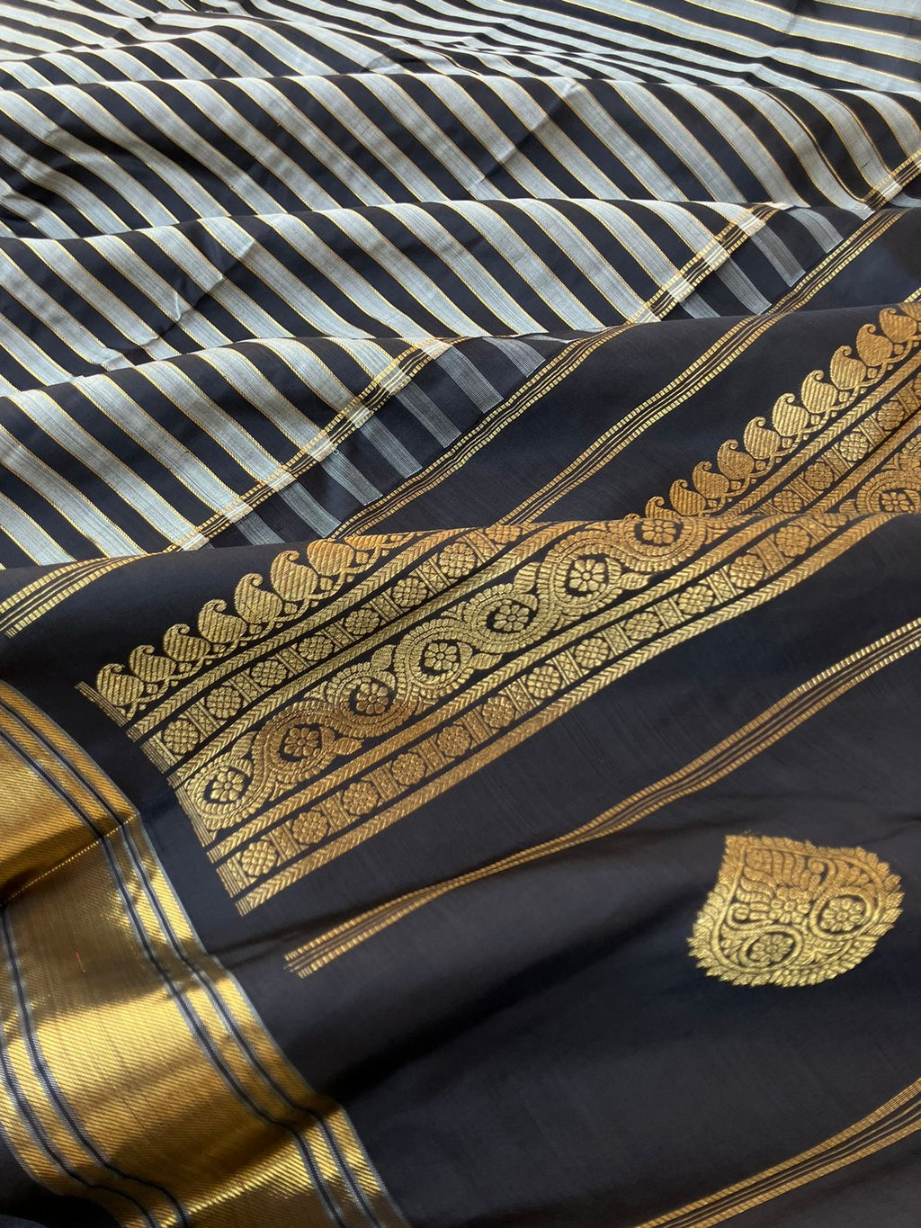 Leela - Darker effects on Kanchivaram - gorgeous black and grey stripes woven body highlighted with gold zari stripes !!