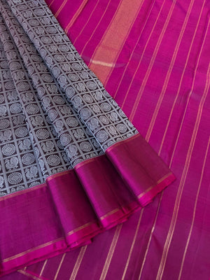 Haritham - Heirloom Yarn Play on Kanchivaram - black base and silver silk thread woven 1000 Mayil chackaram with magenta borders pallu and blouse