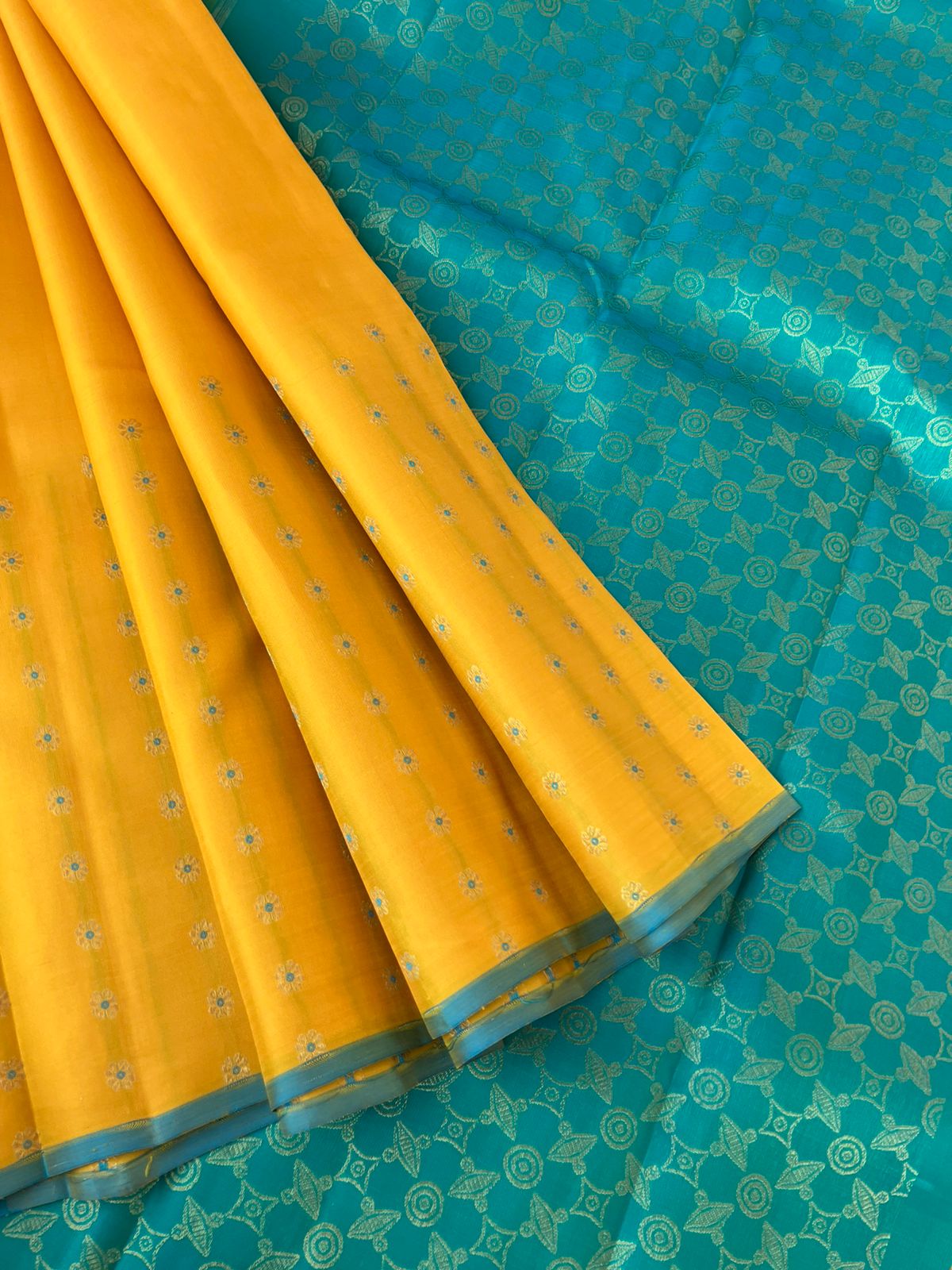 Colour Effects of Kanchivaram - beautiful one of a kind yellow and teal zari woven pallu and blouse with one side meenakarai woven buttas borders with plain body