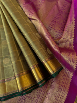 Radhee - Rare Find Kanchivarams - stunning deep elachi green and majenta mayil chackaram with solid gold zari woven borders