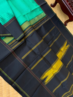 Bliss of Korvai Kanchivaram - deep mint green posi kattam woven body with black borders pallu and blouse