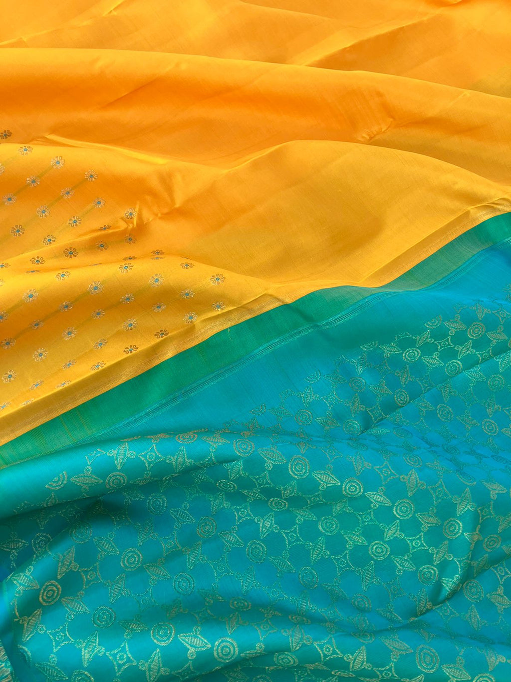 Colour Effects of Kanchivaram - beautiful one of a kind yellow and teal zari woven pallu and blouse with one side meenakarai woven buttas borders with plain body