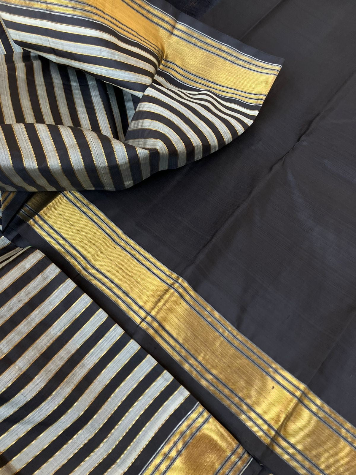 Leela - Darker effects on Kanchivaram - gorgeous black and grey stripes woven body highlighted with gold zari stripes !!