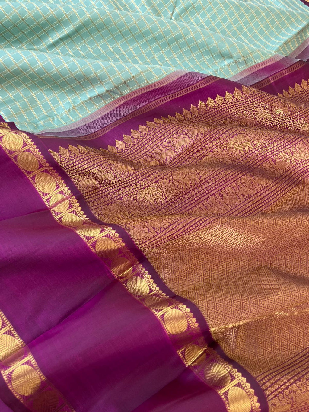 Statement of Kanchivaram - Something Different - all about this sarees is details and the colour combination ( gold and silver zari veldhari chex ) with contrast purple retta pett woven borders